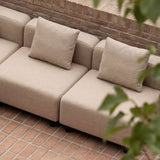 Beiges modulares sackit Outdoor Sofa mit zwei weichen Rückenkissen auf einer Backstein Terrasse im skandinavischen Design | Cobana Lounge Sofa - 3 seater w/ Patio Storage Table - Kirra Sand Mit Armlehnen Mit Hocker | SACKit