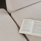 Nahaufnahme eines hellen Fjord Sofas von sackit mit offenem Buch auf der Sitzfläche und weicher skandinavischer Stoffpolsterung | Fjord Sofa - 2 seater w/ open end - Cosmo Terracotta Links | SACKit