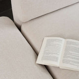 Nahaufnahme des beigefarbenen Fjord Ecksofas von sackit mit offenem Ende und einem aufgeschlagenen Buch auf der weichen Polsterung | Fjord Sofa - Corner Sofa w/ open end - Cosmo Terracotta | SACKit