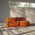 Orangefarbenes modulares Boneless Sofa von sackit in einem hellen Innenraum mit weichen Polstern und warmem Sonnenlicht durch große Fenster