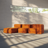 Oranges modulares Sofa ohne Gestell von sackit in einem hellen Wohnraum mit weichen Polstern und markanten Licht Schattenmustern am Boden