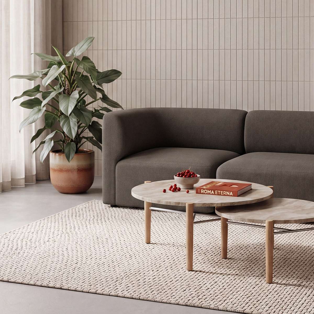 Skandinavisches Wohnzimmer mit dunkelgrauem Fjord Sofa für zwei Personen von sackit neben runden Couchtischen auf einem hellen Teppich und mit großer Zimmerpflanze | Fjord Sofa - 2 seater - Cosmo Olive | SACKit