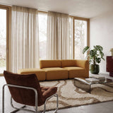 Senfgelbes Fjord Sofa für zwei Personen mit offenem Seitenelement in einem hellen skandinavischen Wohnzimmer mit Vorhängen Pflanzen und Couchtisch von sackit Deutschland | Fjord Sofa - 2 seater w/ open end - Cosmo Terracotta Links | SACKit