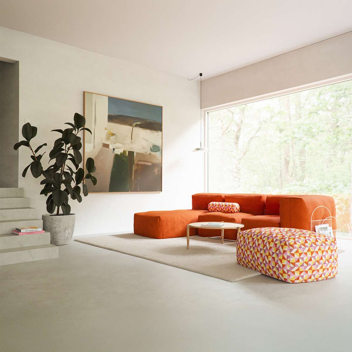 Dreisitziges Soft Sofa Indoor von sackit in warmem Orange mit integrierter Chaiselongue und gemustertem Pouf in einem hellen Wohnzimmer