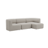 Beiges dreisitziges Sofa mit rechter Ottomane und weich abgerundeten Polstern vor schwarzem Hintergrund von sackit